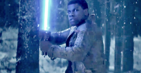 Film still of Finn holding a lightsaber