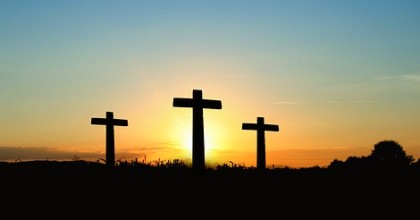 Photo of three crosses at sunset