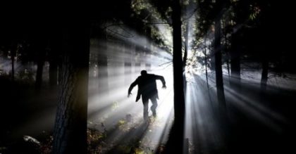 Image of backlit Frankenstein creature running through the woods