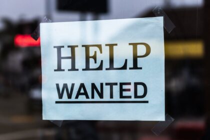 help wanted sign on glass